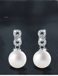 Detailed view of S925 silver pearl earrings with Moissanite stone and infinity charm