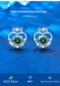 Close-up of S925 silver bow stud earring with heart frame and green moissanite stone
