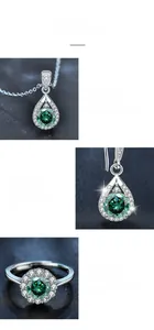 Macro details of green moissanite jewelry set including teardrop necklace and ring