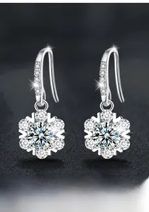Macro detail of S925 sterling silver snowflake earrings with moissanite center stones