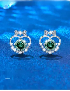 Detail view of 925 silver heart bow stud earrings with 3EX cut green moissanite