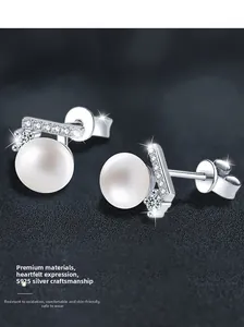 Macro shot of S925 sterling silver pearl earrings with Moissanite stones on grey background