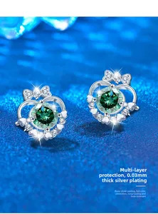 Detail of silver heart crown earrings with green stones and 0.03mm nano-plating finish