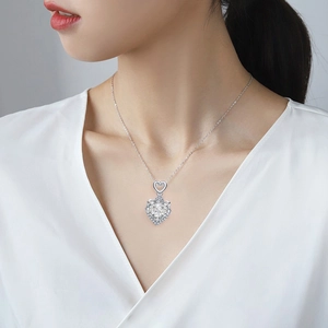 Elegant 925 sterling silver necklace with large heart-cut moissanite pendant on a model