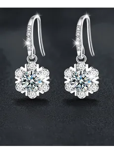 Macro detail of snowflake earrings showing 3EX cut moissanite with 58 facets and fire