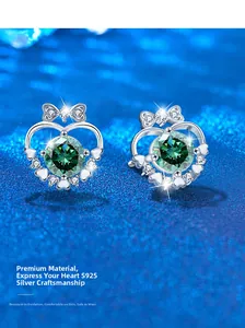 Macro shot of S925 sterling silver bow heart studs with green gemstone and micro-pavé detail