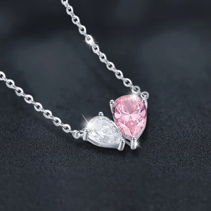 925 silver necklace featuring pink and white pear-cut zircon heart pendant on black background