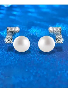 Macro detail of freshwater pearl earrings with 3EX moissanite in geometric 925 silver setting