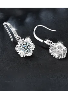 Macro shot of S925 silver snowflake earrings with sparkling round cut moissanite stones