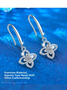 Macro shot of S925 sterling silver four-leaf clover earrings with sparkling zircon