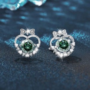 Bow heart 925 silver stud earrings with green moissanite stones on dark blue background