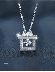 Close-up of S925 silver gift box pendant with moissanite and bowknot detail