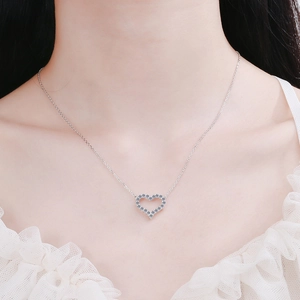 925 silver heart pendant necklace with shimmering crystals on a female model