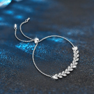 Elegant 925 sterling silver wheat ear bracelet with sparkling stones on blue background