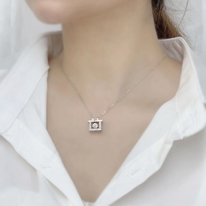 Elegant 925 silver necklace with dancing square moissanite pendant on a white shirt