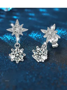 Detail of S925 sterling silver star stud earrings with dangling round moissanite stones