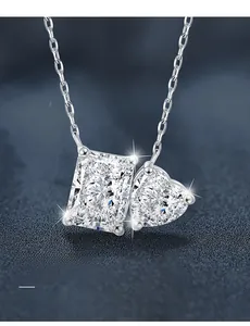 Macro detail of 3EX cut rectangular and heart shaped moissanite pendants on silver chain