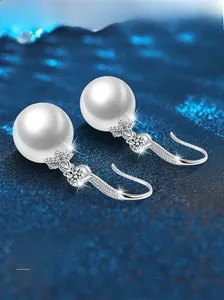 Macro detail of pearl drop earrings with S925 sterling silver hooks and zircon accents