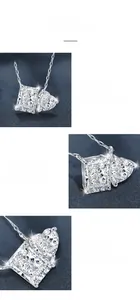 Macro detail of emerald cut and heart moissanite pendant with 925 silver prong setting