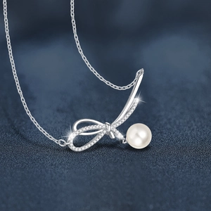 925 silver bow necklace with sparkling moissanite stones and a lustrous white pearl pendant