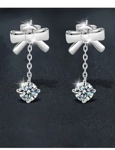 Detail of 925 silver bow earrings with 3EX cut moissanite stones and 58 facets