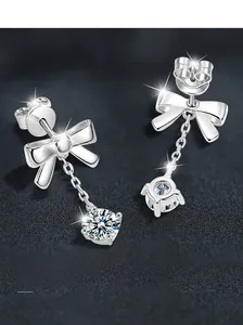 Macro detail of S925 silver bowknot earrings with long tassels and sparkling round stones
