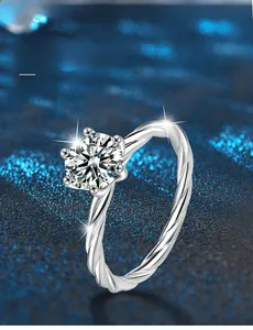 Macro view of six-prong moissanite ring with twisted band and 58-facet 3EX cut main stone