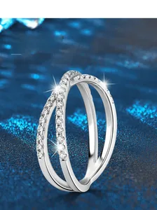 Macro shot of S925 sterling silver crossed ring band featuring micro-pave setting