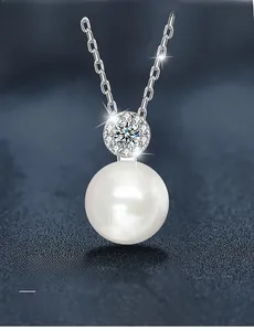 Detail of round white pearl pendant with 3EX moissanite accent on S925 silver chain
