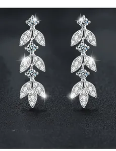 Macro shot of 925 silver leaf earrings with moissanite featuring 58 facets and 3EX cut