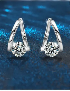 Macro view of S925 sterling silver V-shape earrings with a brilliant round moissanite