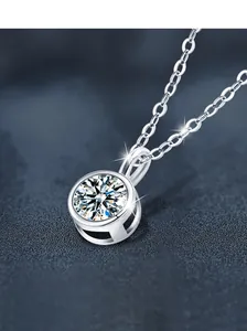 Macro shot of 1ct Moissanite bubble pendant in S925 silver on textured blue backdrop