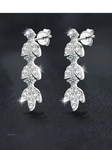 Macro shot of S925 sterling silver leaf earrings with shimmering moissanite stones