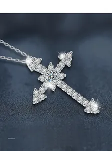 Close-up of S925 sterling silver cross pendant featuring sparkling moissanite stones