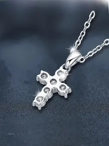 Macro shot of S925 sterling silver cross pendant with five sparkling moissanite stones