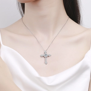 Elegant S925 sterling silver cross necklace with pavé moissanite on a female model