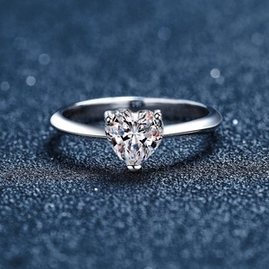 Polished S925 sterling silver ring with large heart-shaped moissanite on blue background
