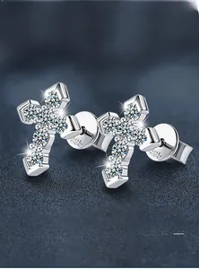 Macro shot of S925 sterling silver cross earrings with sparkling moissanite pave setting
