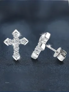 Macro shot of S925 sterling silver cross earrings with sparkling cubic zirconia pavé setting