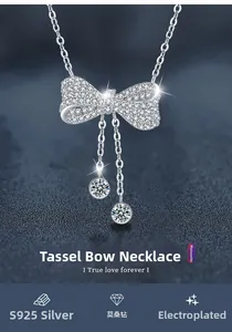 Close-up of S925 silver bow tassel pendant with brilliant moissanite stones and plating