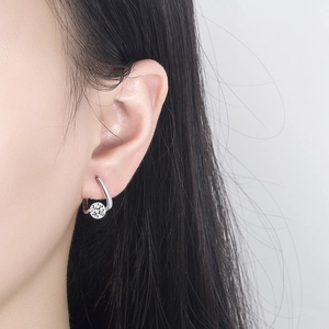 Elegant 925 sterling silver moissanite stud earrings shown on model with U-shaped hook