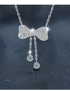 Macro shot of 925 silver bow pendant with 3EX cut moissanite and 58 facets detail