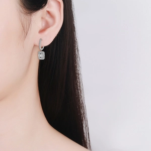 Elegant 925 sterling silver radiant cut moissanite drop earrings worn by a model