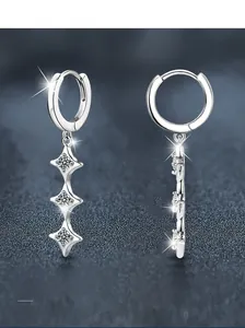 Detail of S925 sterling silver long drop earrings with star-shaped moissanite inlays