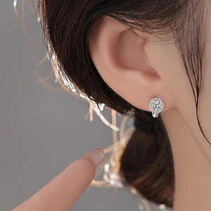 Sparkling S925 sterling silver halo sunflower hoop earrings worn by a model