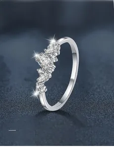 Macro detail of silver sterling ring featuring marquise-cut moissanite stones and 3EX cut