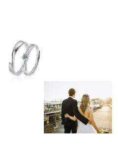 Close-up of S925 silver Moebius couple rings featuring a sparkling moissanite solitaire
