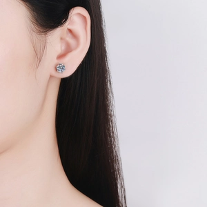 Classic six-prong round moissanite stud earrings in S925 sterling silver worn on ear