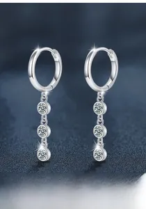 Macro shot of 925 sterling silver moissanite tassel earrings with sparkling drop stones