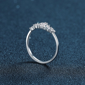Elegant crown-shaped silver ring featuring marquise-cut Moissanite stones on a blue background